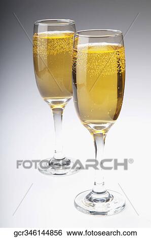 Close-up of two glasses of champagne View Large Photo Image Stock Photograph - Close-up of two glasses of champagne. Fotosearch