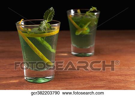 Close-up of two glasses of mint cocktail View Large Photo Image Stock Image - Close-up of two glasses of mint cocktail. Fotosearch