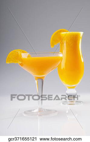 Close-up of two glasses of orange juice View Large Photo Image Stock Image - Close-up of two glasses of orange juice. Fotosearch