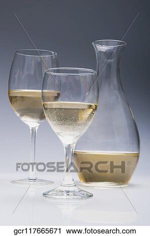 Close-up of two glasses of white wine with a pitcher View Large Photo Image Stock Image - Close-up of two glasses of white wine with a pitcher. Fotosearch
