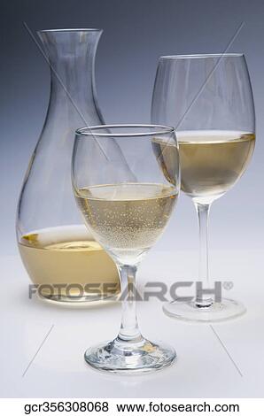 Close-up of two glasses of white wine with a pitcher View Large Photo Image Stock Photo - Close-up of two glasses of white wine with a pitcher. Fotosearch