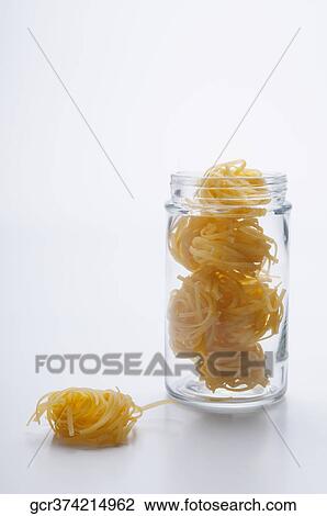 Close-up of uncooked pappardelle pasta in a jar View Large Photo Image Stock Image - Close-up of uncooked pappardelle pasta in a jar. Fotosearch
