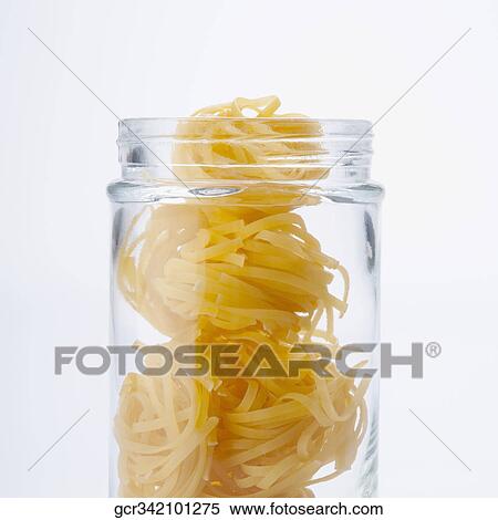 Close-up of uncooked pappardelle pasta in a jar View Large Photo Image Stock Photography - Close-up of uncooked pappardelle pasta in a jar. Fotosearch