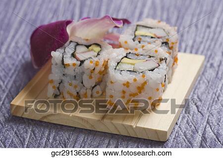 Close-up of uramaki sushi on a cutting board View Large Photo Image Stock Image - Close-up of uramaki sushi on a cutting board. Fotosearch