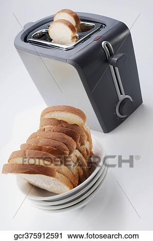 Close-up of white breads in a bowl with a toaster View Large Photo Image Stock Image - Close-up of white breads in a bowl with a toaster. Fotosearch