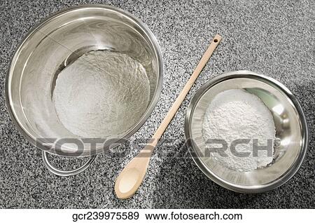 Close-up two bowls of flour with a wooden spoon View Large Photo Image Stock Photo - Close-up two bowls of flour with a wooden spoon. Fotosearch