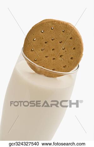Cookie with a glass of milk View Large Photo Image Stock Image - Cookie with a glass of milk. Fotosearch