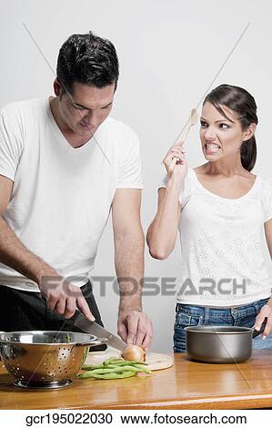 Stock Image - Couple cooking together. Fotosearch