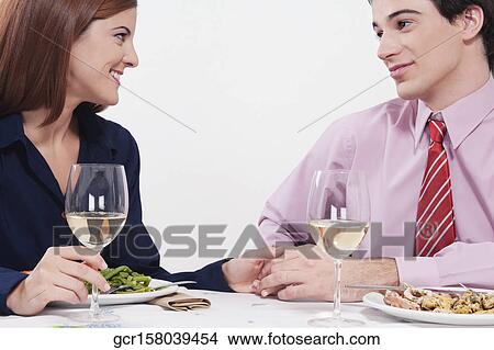 Picture - Couple enjoying dinner together. Fotosearch