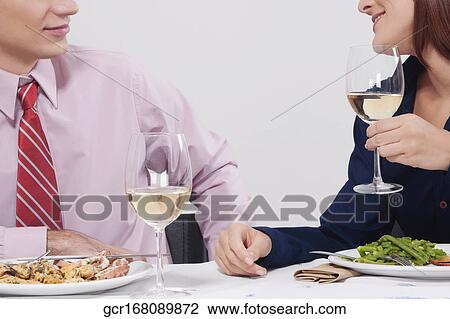 Couple enjoying dinner together View Large Photo Image Stock Image - Couple enjoying dinner together. Fotosearch