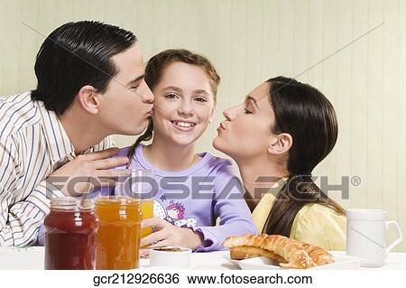 Couple kissing their daughter View Large Photo Image Stock Photograph - Couple kissing their daughter. Fotosearch
