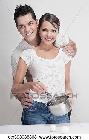 Couple preparing food in the kitchen View Large Photo Image Stock Photo - Couple preparing food in the kitchen. Fotosearch