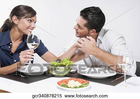 Couple romancing at dining table View Large Photo Image Stock Photography - Couple romancing at dining table. Fotosearch