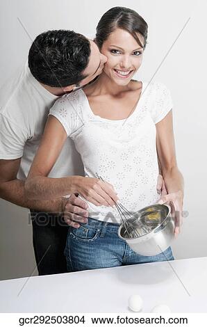 Couple romancing in a kitchen View Large Photo Image Picture - Couple romancing in a kitchen. Fotosearch