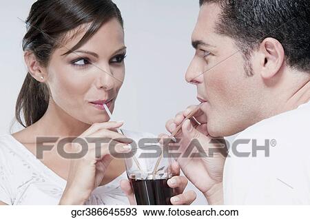 Couple sharing a cola beverage View Large Photo Image Stock Image - Couple sharing a cola beverage. Fotosearch