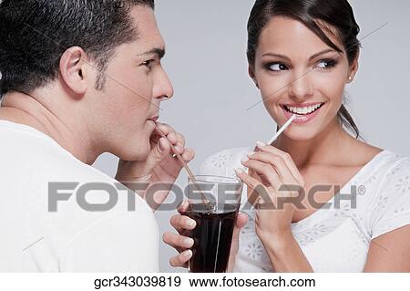 Couple sharing a cola beverage View Large Photo Image Stock Photo - Couple sharing a cola beverage. Fotosearch