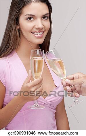 Couple toasting champagne flute View Large Photo Image Stock Photograph - Couple toasting champagne flute. Fotosearch