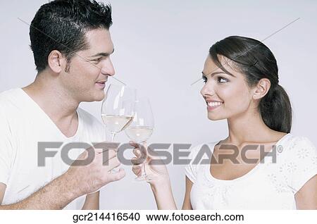 Couple toasting with white wine glasses View Large Photo Image Stock Image - Couple toasting with white wine glasses. Fotosearch