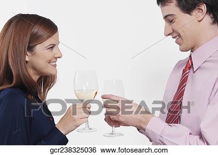 Couple toasting with wine glasses View Large Photo Image Stock Photograph - Couple toasting with wine glasses. Fotosearch