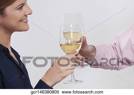 Stock Photography - Couple toasting with wine glasses. Fotosearch