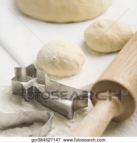 Dough with rolling pin and pastry cutters View Large Photo Image Stock Photo - Dough with rolling pin and pastry cutters. Fotosearch