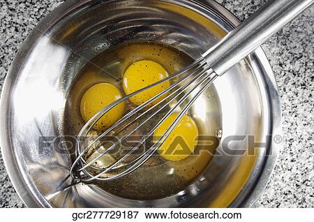 Egg yolk with an egg beater in a bowl View Large Photo Image Stock Photo - Egg yolk with an egg beater in a bowl. Fotosearch