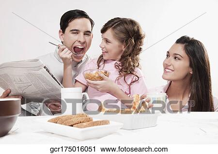 Stock Image - Family at a breakfast table. Fotosearch