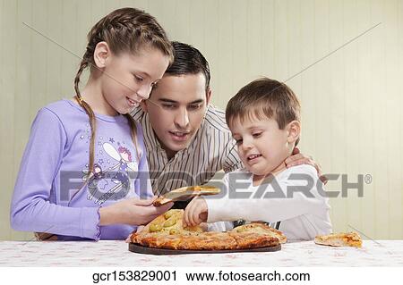 Family sharing a pizza View Large Photo Image Stock Image - Family sharing a pizza. Fotosearch