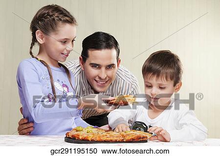 Family sharing a pizza View Large Photo Image Stock Image - Family sharing a pizza. Fotosearch