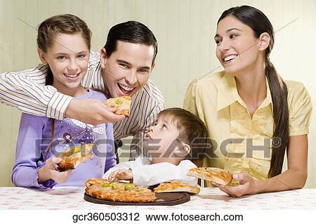 Family sharing a pizza View Large Photo Image Stock Image - Family sharing a pizza. Fotosearch