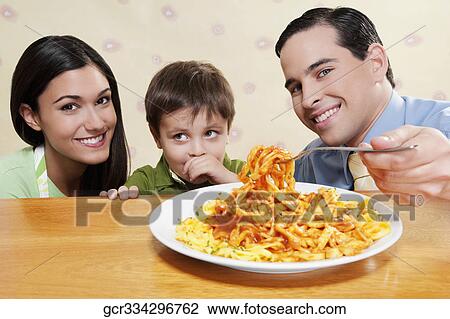 Family sharing fettuccine pasta View Large Photo Image Stock Image - Family sharing fettuccine pasta. Fotosearch