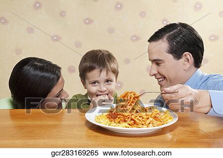 Family sharing fettuccine pasta View Large Photo Image Stock Photography - Family sharing fettuccine pasta. Fotosearch