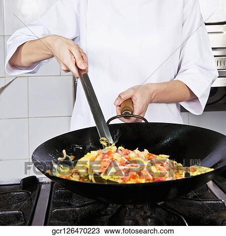 Female chef cooking food in the kitchen View Large Photo Image Stock Image - Female chef cooking food in the kitchen. Fotosearch