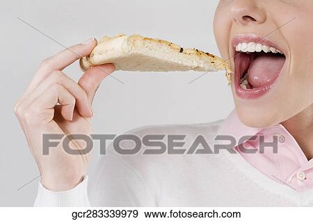Female chef eating a slice of pizza View Large Photo Image Stock Photo - Female chef eating a slice of pizza. Fotosearch