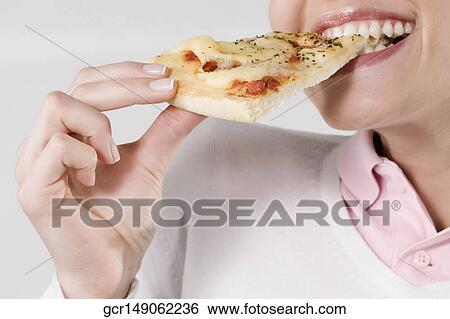 Female chef eating a slice of pizza View Large Photo Image Stock Photograph - Female chef eating a slice of pizza. Fotosearch