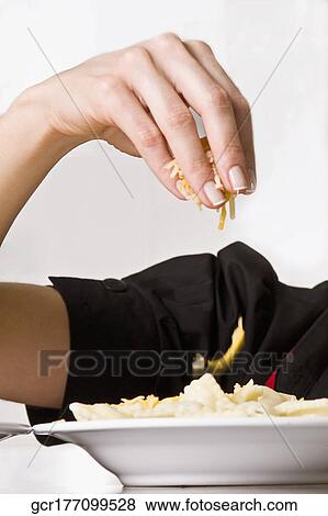 Female chef garnishing food View Large Photo Image Stock Photo - Female chef garnishing food. Fotosearch