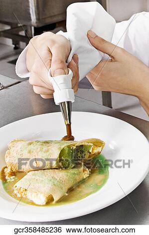 Female chef icing pastries View Large Photo Image Stock Photograph - Female chef icing pastries. Fotosearch