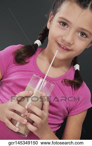 Girl drinking chocolate milkshake View Large Photo Image Stock Image - Girl drinking chocolate milkshake. Fotosearch
