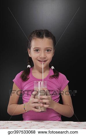 Girl drinking chocolate milkshake View Large Photo Image Stock Photo - Girl drinking chocolate milkshake. Fotosearch