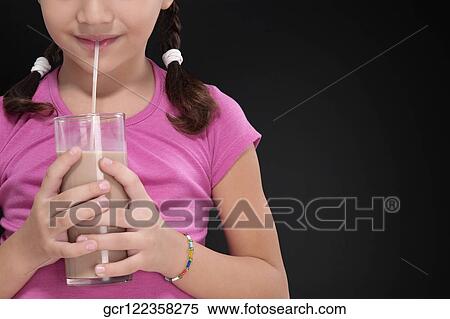 Girl drinking chocolate milkshake View Large Photo Image Stock Photography - Girl drinking chocolate milkshake. Fotosearch