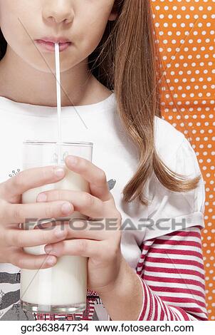 Girl drinking milk with a straw View Large Photo Image Picture - Girl drinking milk with a straw. Fotosearch