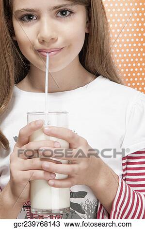 Girl drinking milk with a straw View Large Photo Image Stock Image - Girl drinking milk with a straw. Fotosearch