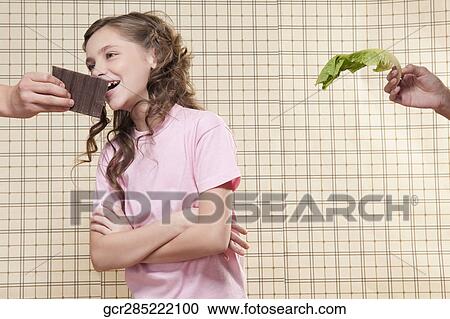 Girl eating chocolate View Large Photo Image Stock Image - Girl eating chocolate. Fotosearch