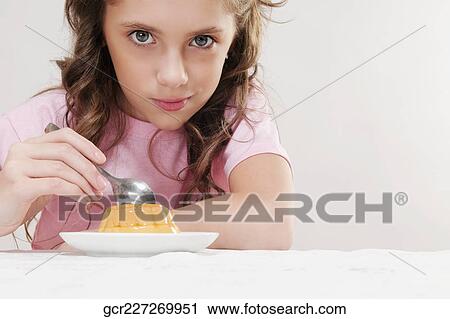 Stock Image - Girl eating jelly. Fotosearch