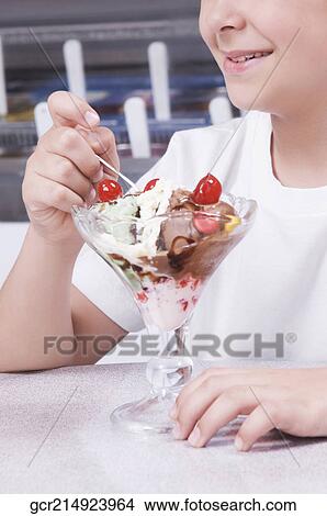 Girl enjoying ice cream View Large Photo Image Picture - Girl enjoying ice cream. Fotosearch