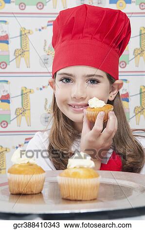 Girl holding a cupcake View Large Photo Image Stock Image - Girl holding a cupcake. Fotosearch