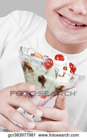 Girl holding a glass of ice cream and smiling View Large Photo Image Stock Image - Girl holding a glass of ice cream and smiling. Fotosearch