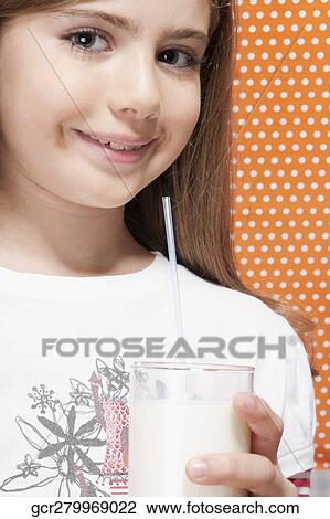 Girl holding a glass of milk View Large Photo Image Stock Image - Girl holding a glass of milk. Fotosearch