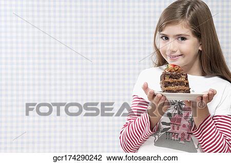 Girl holding a plate of chocolate pastry View Large Photo Image Stock Image - Girl holding a plate of chocolate pastry. Fotosearch