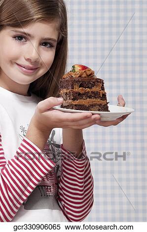 Girl holding a plate of chocolate pastry View Large Photo Image Stock Photography - Girl holding a plate of chocolate pastry. Fotosearch